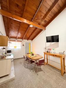 a kitchen with a table and chairs in a room at Villa Valeria in General Acha