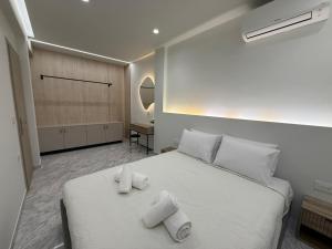 a bedroom with a white bed with towels on it at Meraki Luxury Retreat in Kos
