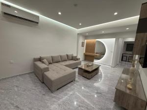 a living room with a couch and a table at Meraki Luxury Retreat in Kos