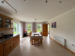 a kitchen and dining room with a table and chairs at Kilmurry heights in Kenmare