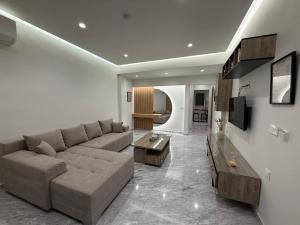 a large living room with a couch and a tv at Meraki Luxury Retreat in Kos