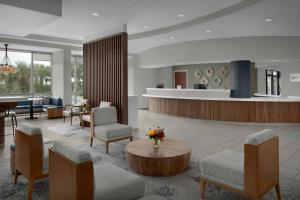 a lobby with a waiting area with chairs and a table at Courtyard by Marriott Carolina Beach Oceanfront in Carolina Beach +54 photos