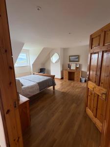 a bedroom with a bed and a wooden floor at Kilmurry heights in Kenmare