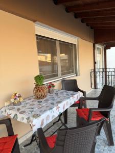a table and chairs on a patio at Dimi's Apartment Avdira in Ávdhira