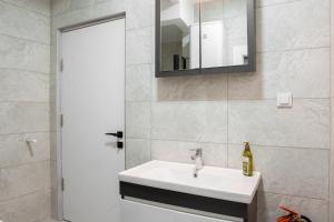 a bathroom with a white sink and a mirror at Defne House Urla in Urla +44 photos