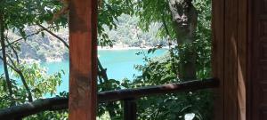 a view of a lake from a window at Comfortable lakeside house! in Güéjar-Sierra