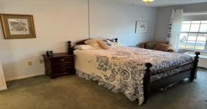 a bedroom with a bed and a chair and a window at Serene Florida Oasis in Inverness