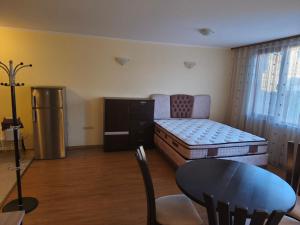 a living room with a bed and a table and a tableablish at Апартаменти-Студия в Комплекс Нестинарка in Tsarevo