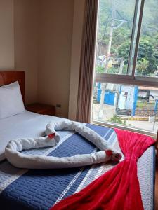 a bed in a room with a large window at Haylli Café Oro Hotel in Santa Teresa