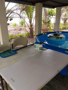 a table with two chairs and a swimming pool at PlayaMariaChiquita in Colón