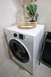 a white washing machine with a basket on top of it at Modern Studio Apartment in Žepče