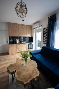 a living room with a blue couch and a table at Modern Studio Apartment in Žepče