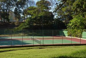 a tennis court with two tennis courts at Hostal Universitario in San German