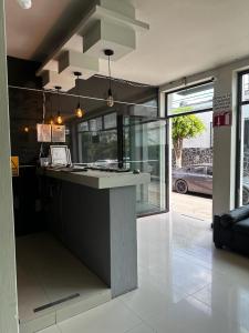 a kitchen with a counter in the middle of a room at Hotel kristal in La Barca