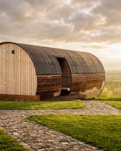 a wooden building with a round roof on a field at Zen Resort & SPA in Purcari