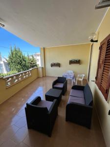 a living room with couches and a table on a balcony at Dream Beach Salento in Porto Cesareo