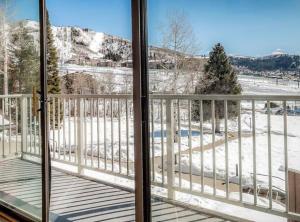 a view of a snow covered field from a balcony at Slopeside Chalet in Steamboat Springs