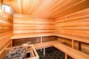 a sauna with wooden walls and benches and a fan at Slopeside Chalet in Steamboat Springs