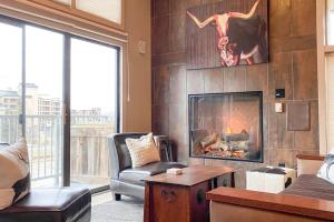 a living room with a fireplace with a skull on the wall at Slopeside Chalet in Steamboat Springs +23 photos