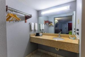 a bathroom with a sink and a mirror at The Lodge at the Falls in Wichita Falls
