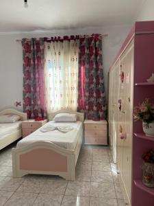 a small bedroom with a bed and a window at Villa Victoria in Gjirokastër