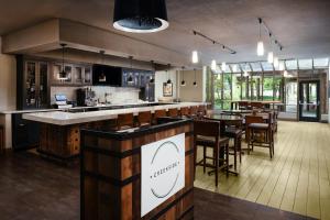 a large kitchen with a bar and a dining room at Hilton Concord in Concord
