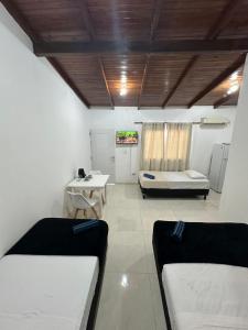 a room with a couch and a bed and a table at Aguara Falls in Puerto Iguazú +5 photos