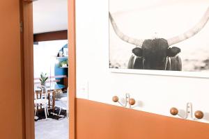 a picture of a bull hanging on a wall at Sunset Sanctuary in Steamboat Springs
