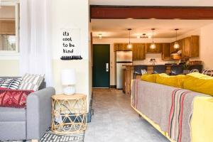 a living room with a couch and a kitchen at Sunset Sanctuary in Steamboat Springs