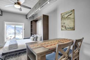 a bedroom with a bed and a table and chairs at Gondola Heights Hideaway in Steamboat Springs