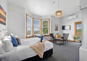 a bedroom with a large bed and a table and chairs at Stanley Seaview Inn in Stanley