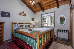a bedroom with a bed in a room with a ceiling at Cabin at the Forest Edge | Hot tub, pet friendly in Packwood
