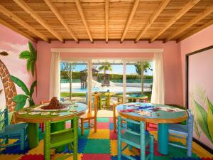 a room with two tables and chairs and a patio at Hotel Novotel Sharm El-Sheikh in Sharm El Sheikh