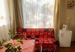 a red couch sitting in front of a window at Refugio Pradera del Sur in Llanquihue