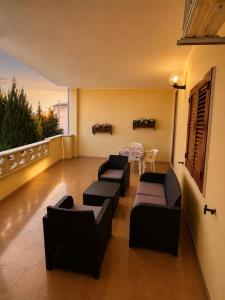 a living room with couches and a table on a balcony at Dream Beach Salento in Porto Cesareo