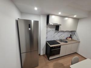 a kitchen with a stainless steel refrigerator and a sink at Apartman Galić Posušje in Posušje