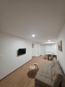 a living room with a couch and a table at Apartman Galić Posušje in Posušje
