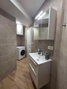 a bathroom with a sink and a washing machine at Apartman Galić Posušje in Posušje +10 photos