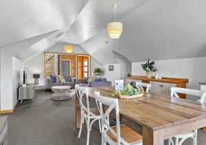 a dining room and living room with a wooden table at Stanley Seaview Inn in Stanley