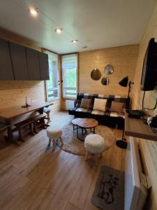a living room with a couch and a table at L'Esprit Boisé in Ustou