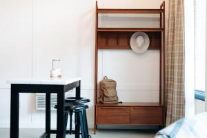 a bedroom with a desk and a table with a backpack at Frontcountry Salida in Salida