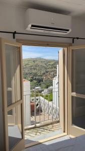 an open door to a balcony with a view at Amerissas studios 4 in Skiros