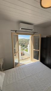 a bedroom with a bed and a window with a view at Amerissas studios 4 in Skiros