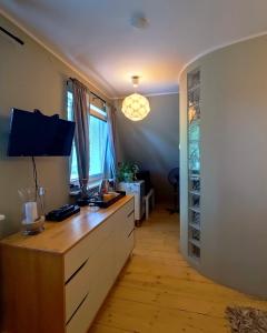 a kitchen with a wooden counter with a wine cellar at Cherry Tree Cozy Rooms in Gdańsk