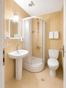 a bathroom with a shower and a toilet and a sink at Luna Hotel in Antalya +28 photos