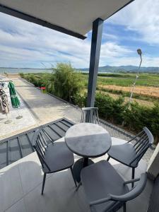 a table and chairs on a balcony with a view at Bran Apartments in Star Dojran