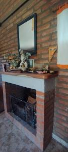 a fireplace with a mirror on top of it at Chalet del Rio in Cuesta Blanca