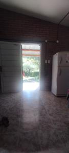 an empty garage with a door and a refrigerator at Chalet del Rio in Cuesta Blanca