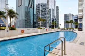 a swimming pool in a city with tall buildings at Luxury executive Studio in Brickell in Miami
