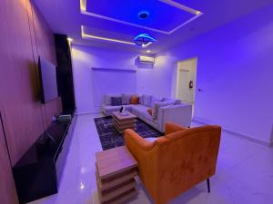 a living room with a couch and a table at Luxury 3 Bedroom Duplex Service Aparment in Abuja in Abuja +13 photos